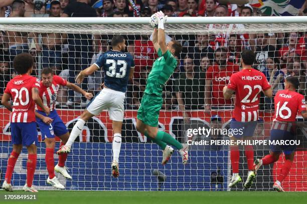 Atletico Madrid's Slovenian goalkeeper Jan Oblak catches the ball next to Feyenoord's Slovak defender David Hancko during the UEFA Champions League...