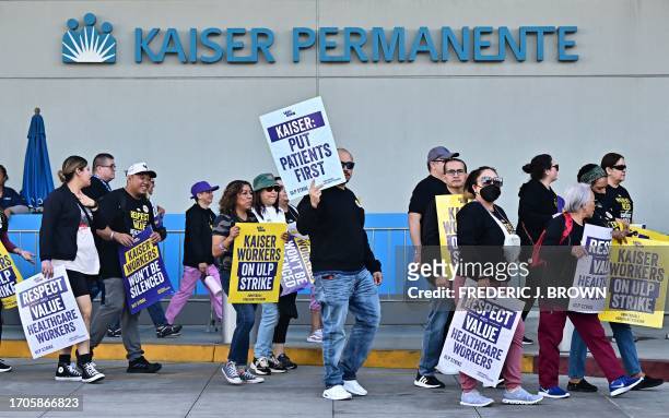 Kaiser Permanente health care employees, joined by Union members representing the workers, walk the picket line in Los Angeles during the start of a...