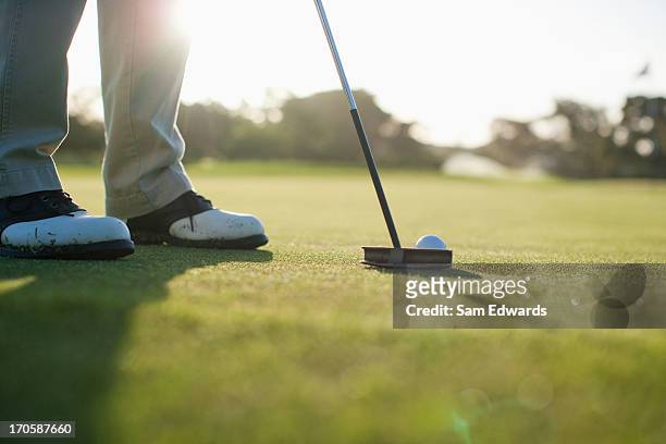 man putting golf ball - golf putter stock pictures, royalty-free photos & images