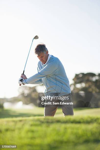 man playing golf in sand trap - golf bunker low angle stock pictures, royalty-free photos & images