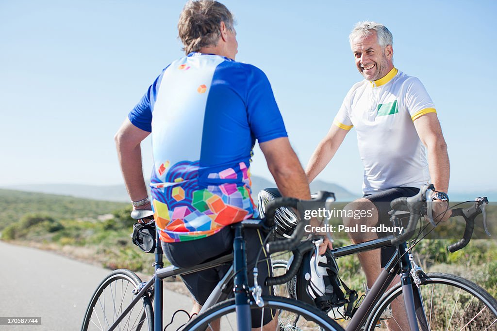 Men talking with bicycles in remote area