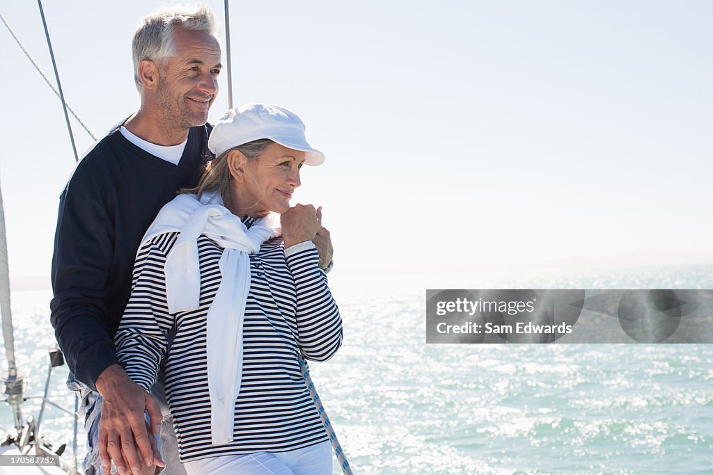 Couple hugging on deck of boat