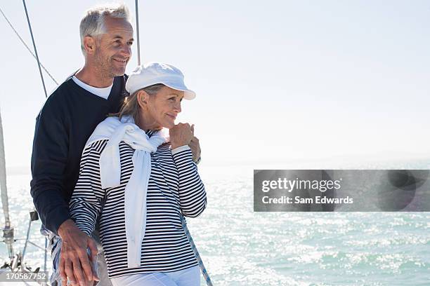 couple hugging on deck of boat - sail boat deck stock pictures, royalty-free photos & images