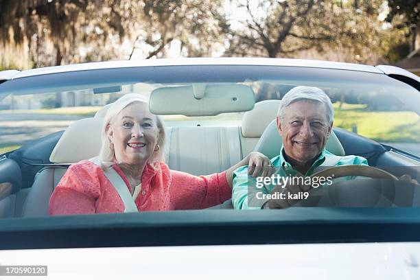 senior couple in convertible - driving car front view stock pictures, royalty-free photos & images