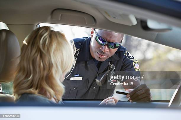 woman pulled over by police - black male police officer stock pictures, royalty-free photos & images