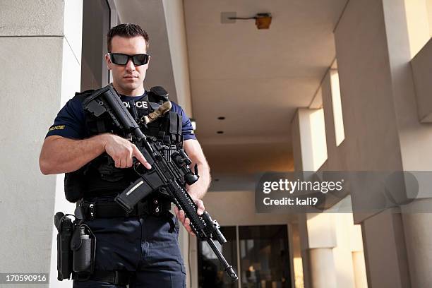 police officer holding rifle - weapon stock pictures, royalty-free photos & images