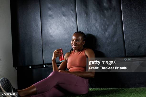 young woman resting after workout at gym - energydrink stock-fotos und bilder