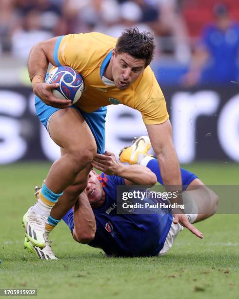 Felipe Arcos Perez of Uruguay is tackled by Tiaan Swanepoel of Namibia during the Rugby World Cup France 2023 match between Uruguay and Namibia at...