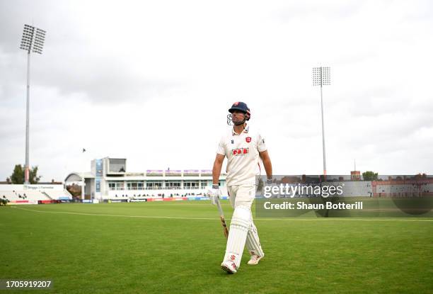 Sir Alastair Cook of Essex walks back to the pavilion after being caught by Lewis McManus of Northamptonshire off the bowling of Ben Sanderson during...