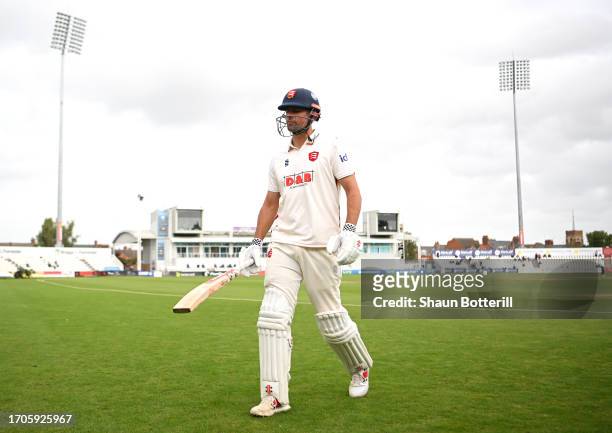 Sir Alastair Cook of Essex walks back to the pavilion after being caught by Lewis McManus of Northamptonshire off the bowling of Ben Sanderson during...