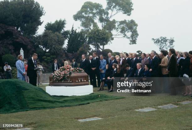 Family and friends attending the funeral of singer Bing Crosby at Holy Cross Cemetery in Los Angeles, California, October 18th 1977. Widow Kathy sits...