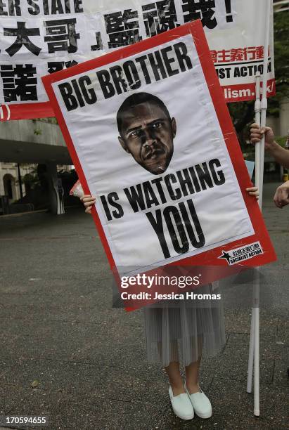 Woman holds up a protest sign in Charter Garden, Central, Hong Kong at the start of the protest rally in support of Edward Snowden, on June 15, 2013...