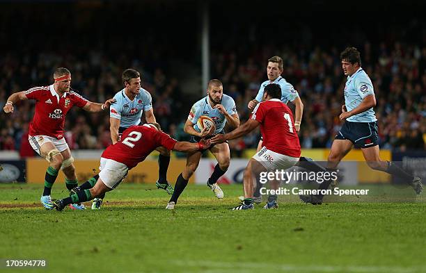 Drew Mitchell of the Waratahs is tackled during the match between the Waratahs and the British & Irish Lions at Allianz Stadium on June 15, 2013 in...