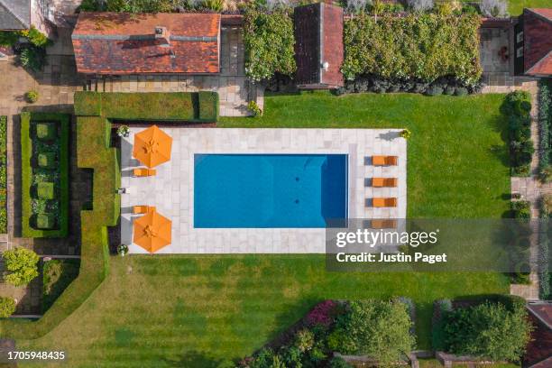 drone view onto a luxury swimming pool in a luxury domestic garden - pool top view stock pictures, royalty-free photos & images
