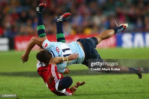 Leigh Halfpenny of the Lions is tackled by Peter Betham of the Waratahs during the match between the NSW Waratahs and the British & Irish Lions at...