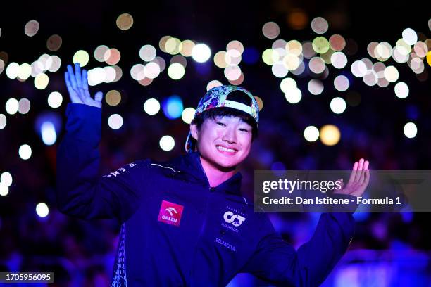 Yuki Tsunoda of Japan and Scuderia AlphaTauri poses in front of the crowd on the fan stage during practice ahead of the F1 Grand Prix of Japan at...