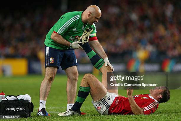 Jamie Roberts of the Lions receives attention after injuring himself during the match between the Waratahs and the British & Irish Lions at Allianz...