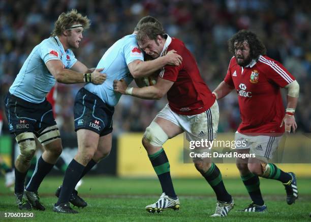 Alun Wyn Jones of the Lions is tackled during the match between the NSW Waratahs and the British & Irish Lions at Allianz Stadium on June 15, 2013 in...