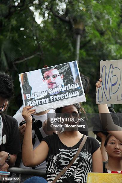 Protesters hold placards outside the U.S. Consulate during a rally in support of Edward Snowden, the former National Security Agency contractor, in...