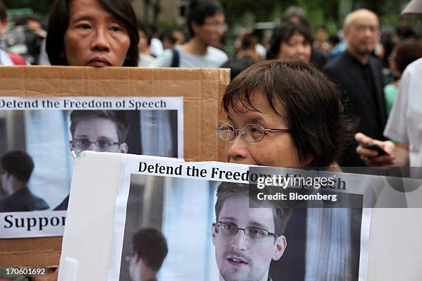 Protesters hold placards during a rally in support of Edward Snowden, the former National Security Agency contractor, in Hong Kong, China, on...