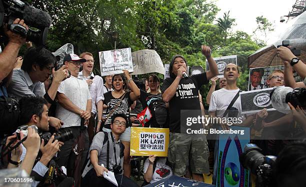 Leung Kwok-hung, a Hong Kong lawmaker and chairman of the League of Social Democrats, center, speaks during a rally in support of Edward Snowden, the...