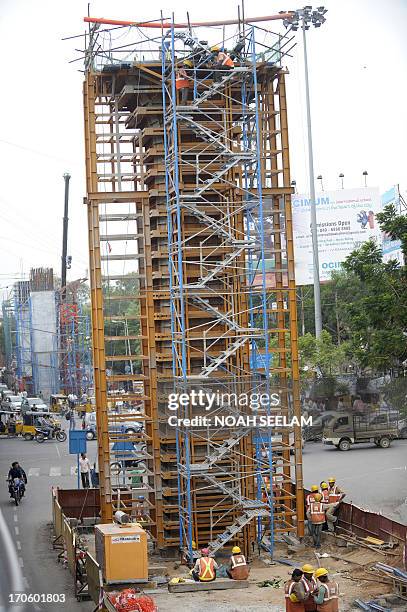 Indian Hyderabad Metro Rail project labourers work at a construction site in Hyderabad on June 15, 2013. Works related to Hyderabad Metro Rail are...