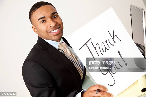 african descent business man suit  white background thank you sign - office holding sign stockfoto's en -beelden