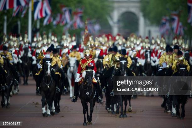 Members of the Household Cavalry ride along the Mall during the Queen's birthday parade 'Trooping the Colour' at in central London on June 15, 2013....