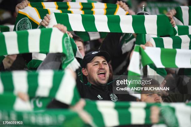 Celtic fans cheer on their team prior to the UEFA Champions League group E football match between Celtic and Lazio at Celtic Park stadium in Glasgow,...