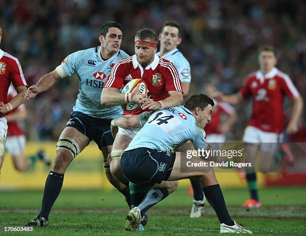 Jamie Heaslip of the Lions is tackled by Cam Crawford during the match between the NSW Waratahs and the British & Irish Lions at Allianz Stadium on...