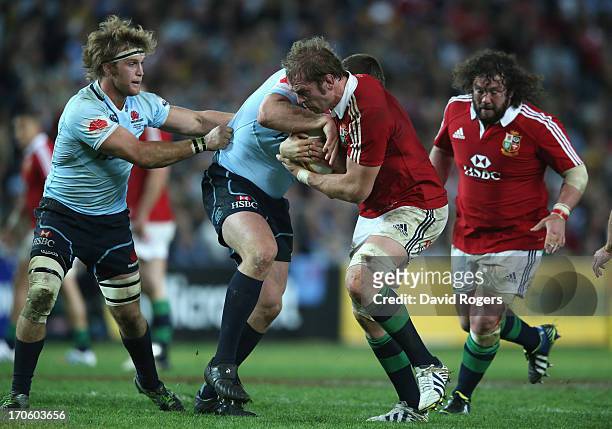 Alun Wyn Jones of the Lions is tackled during the match between the NSW Waratahs and the British & Irish Lions at Allianz Stadium on June 15, 2013 in...