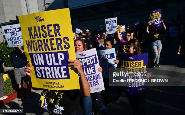 Kaiser Permanente employees, joined by Union members representing the workers, walk the picket line in Los Angeles, California on October 4, 2023....