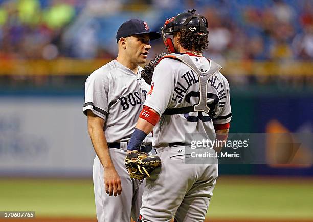 Catcher Jarrod Saltalamacchia of the Boston Red Sox talks with pitcher Alfredo Aceves during the game against the Tampa Bay Rays at Tropicana Field...