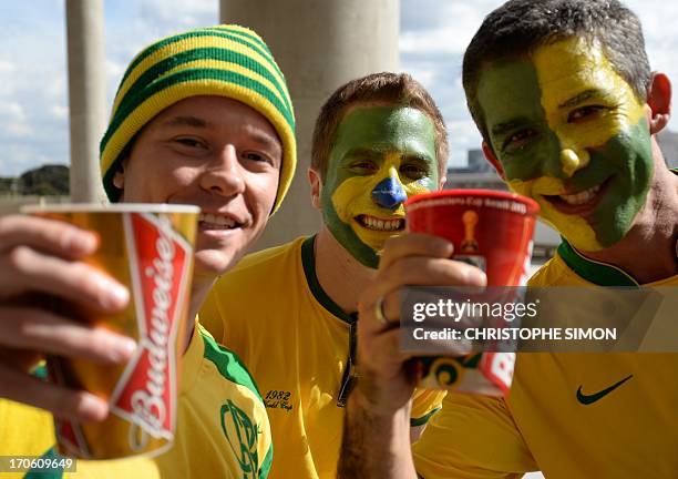 Supporters drink beer as they arrive for the FIFA Confederations Cup Brazil 2013 Group A football match between Brazil and Japan, at the National...