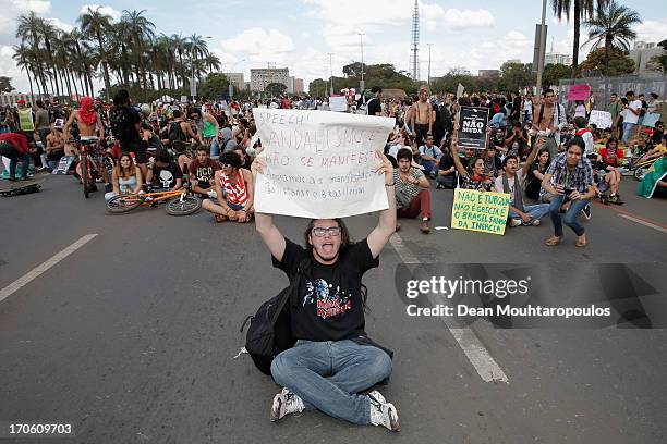 Protestor holds a banner prior to the FIFA Confederations Cup Brazil 2013 Group A match between Brazil and Japan at National Stadium on June 15, 2013...