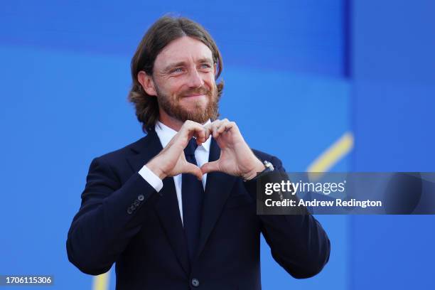 Tommy Fleetwood of Team Europe acknowledges the crowd with a heart gesture during the opening ceremony for the 2023 Ryder Cup at Marco Simone Golf...