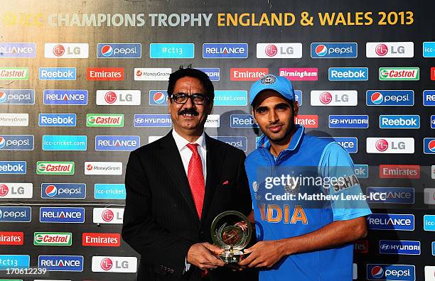 Bhuvneshwar Kumar of India is presented with the 'Man of the Match' award from Gurdeep Singh, President and CEO, Wireless Business Reliance...