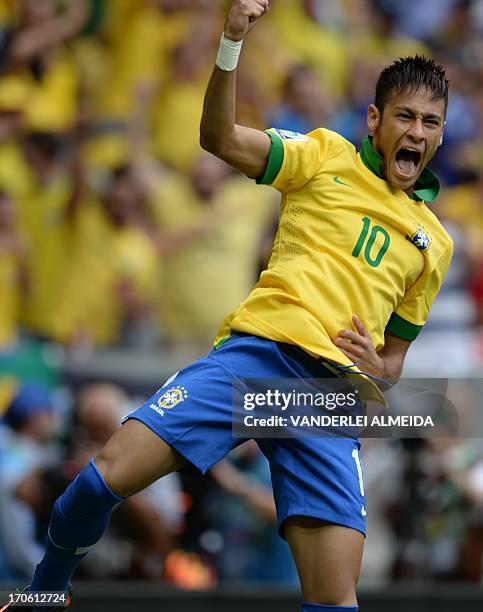 Brazil's forward Neymar celebrates after scoring against Japan during their FIFA Confederations Cup Brazil 2013 Group A football match, at the...