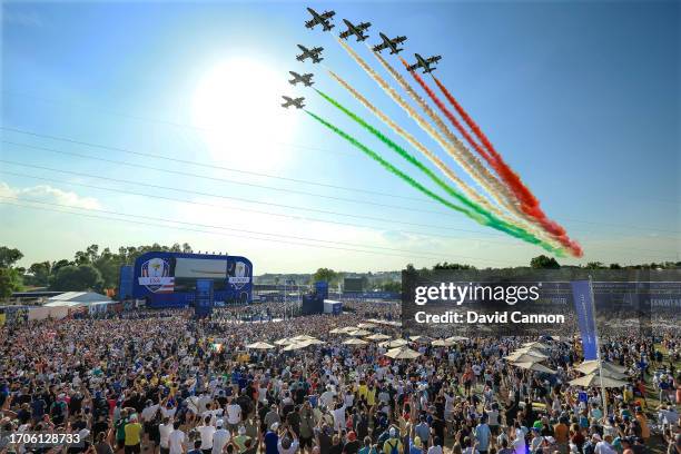 The Italian Air Force display team 'The Frecce Tricolori' fly-over the two teams on stage and thousands of spectators during the opening ceremony for...