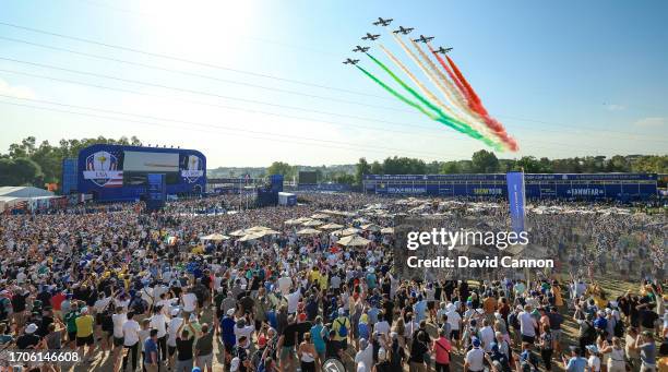 The Italian Air Force display team 'The Frecce Tricolori' fly-over the two teams on stage and thousands of spectators during the opening ceremony for...