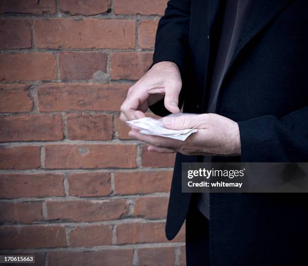 sinister transaction - con man stock pictures, royalty-free photos & images