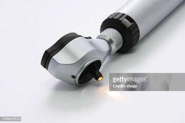 medical instrument...otoscope with lamp turned on - otoscope bildbanksfoton och bilder