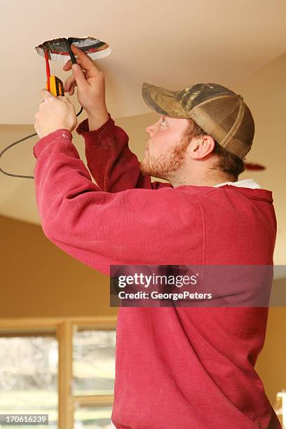 electrician testing wires - installing ceiling light fixture stock pictures, royalty-free photos & images