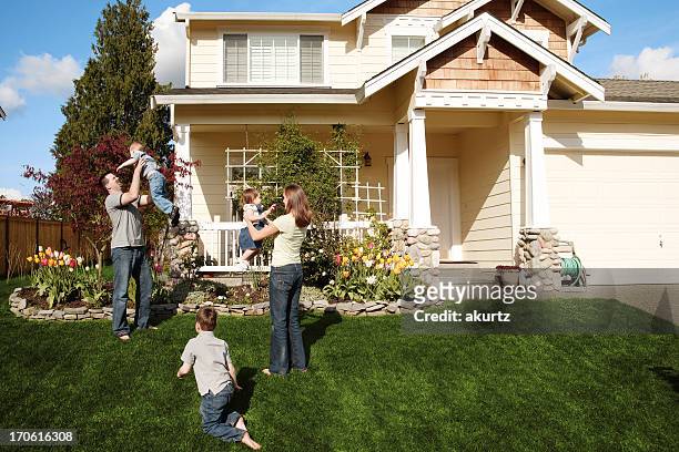 a happy family of five playing in the front yard - fem människor bildbanksfoton och bilder