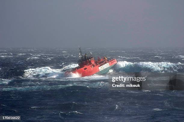 view of a boat drifting in a stormy sea - sailing storm stock pictures, royalty-free photos & images