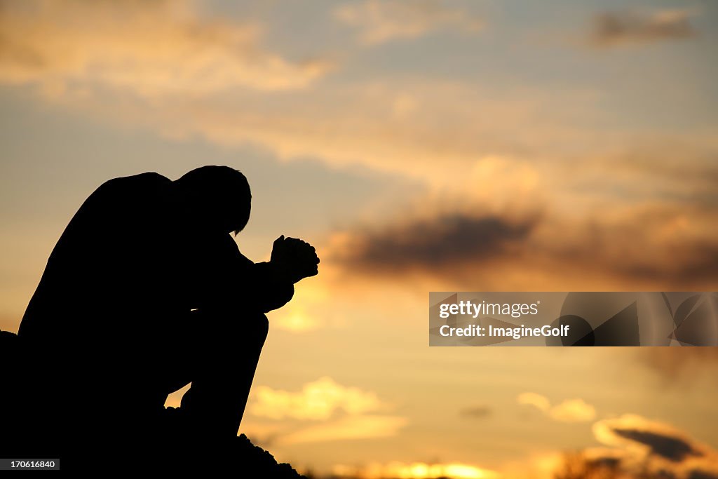 Silhouette of Unrecognizable Man Praying Outside