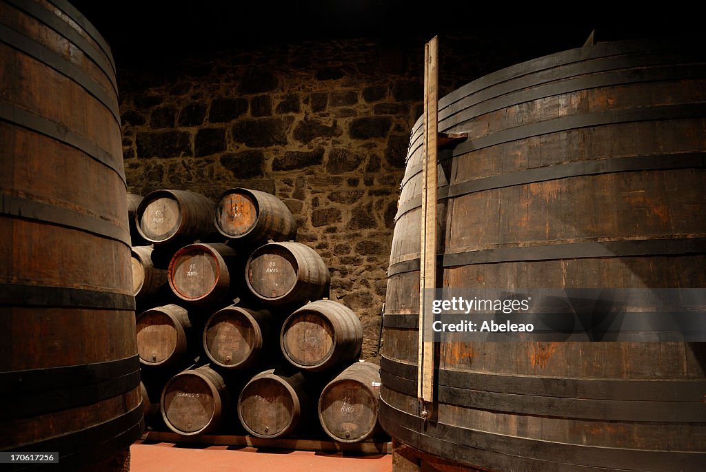 Wine cellar with stacked wine barrels