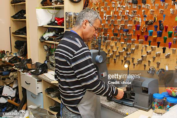 locksmith at work....making spare key - locksmith stock pictures, royalty-free photos & images