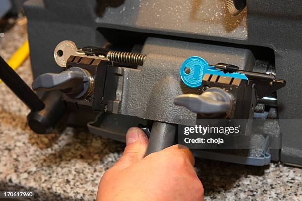 locksmith at work....making spare key - locksmith stock pictures, royalty-free photos & images