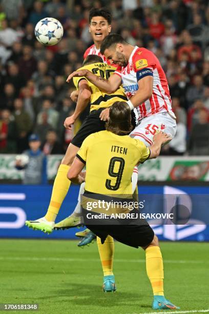 Red Star's Austrian defender Aleksandar Dragovic fights for the ball with Young Boys' Swiss midfielder Darian Males and Young Boys' Swiss forward...